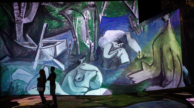 People look over the Imagine Picasso Atlanta: Immersive Art Exhibition on opening day at Pullman Yards in Atlanta Thursday, 17 2022.   STEVE SCHAEFER FOR THE ATLANTA JOURNAL-CONSTITUTION