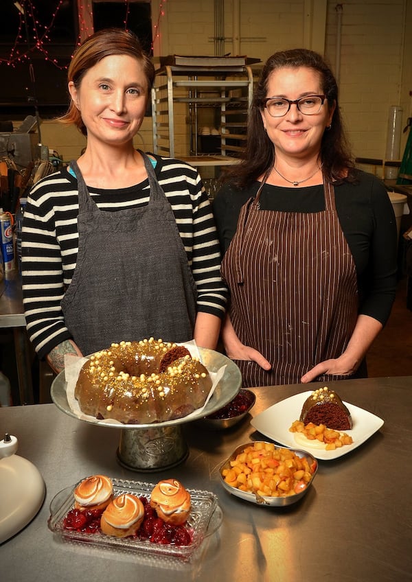 Rebecca Weil, left, and Joy Jessup, owners of Sugar Spun Fun, pose with their Ginger Cake and Eggnog Cream Puffs with Eggnog Pastry Cream and toppings, the recipes for which they shared. (Chris Hunt/Special)