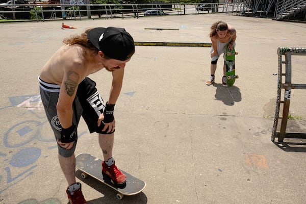 Skateboarders Anthony Eadens and Tommy Wright catch their breath after skating at the Dave Armstrong Extreme Park on Sunday, June 22, 2025, in Louisville, Ky. (AP Photo/Jon Cherry)