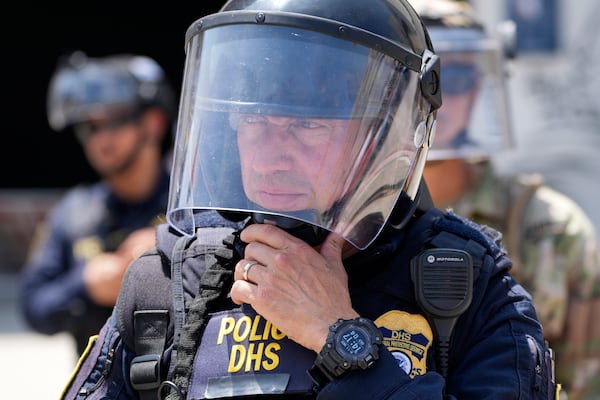 National Guard and DHS police stand guard outside the Metropolitan Detention Center, Wednesday, June 11, 2025, in Los Angeles. (AP Photo/Damian Dovarganes)