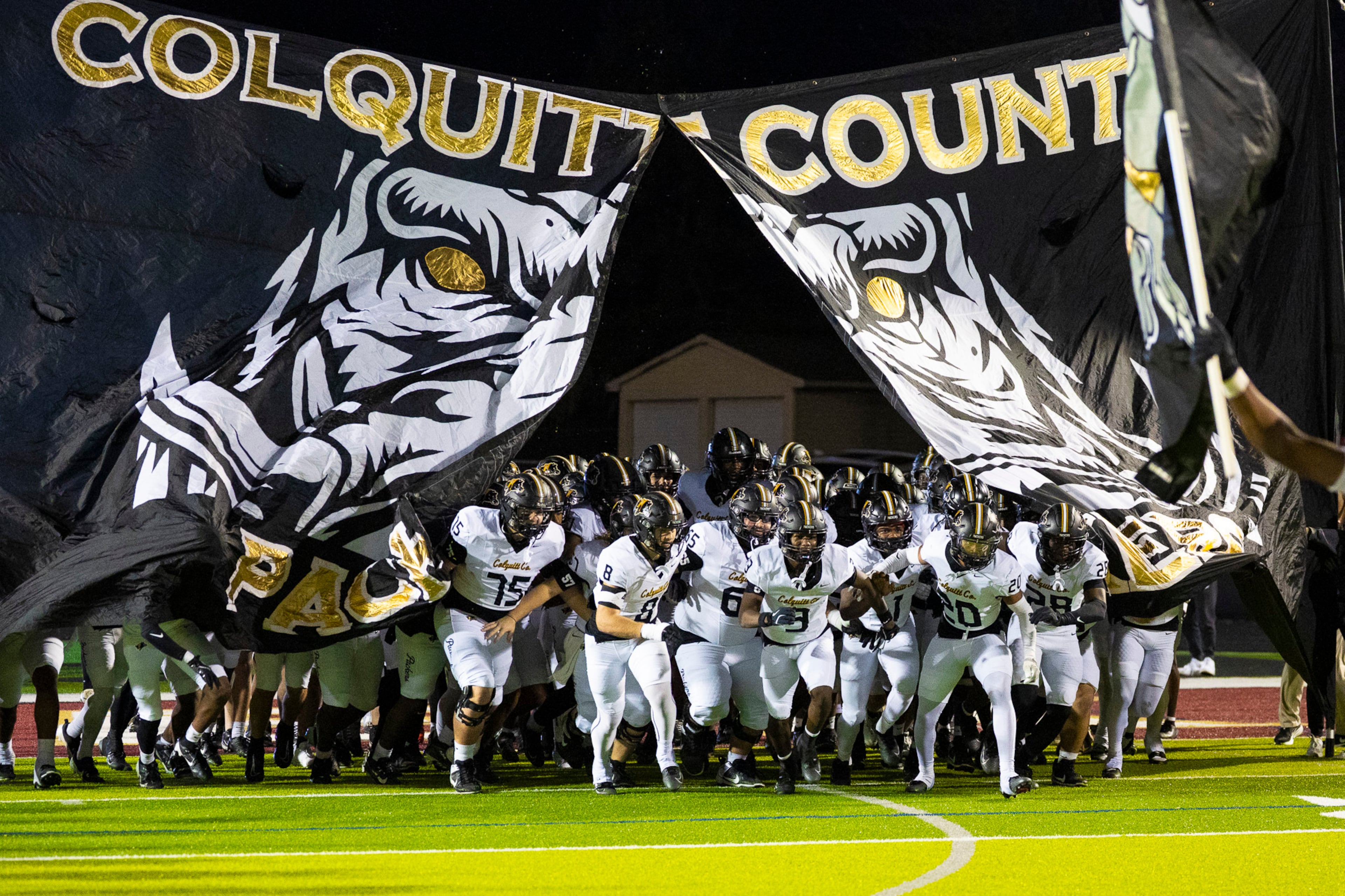 Colquitt players run through the banner against Mill Creek at Mill Creek Community Stadium in Hoschton on Nov. 14th, 2025. (Oscar Guevara Saenz for the AJC)