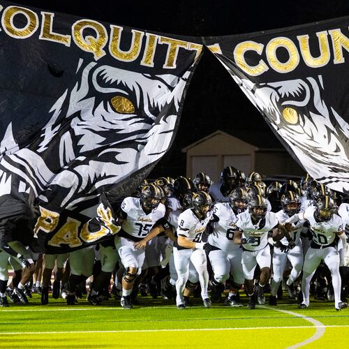 Colquitt County players (who call themselves the Packers) run through their Packer hog banner before their game against Mill Creek at Mill Creek Community Stadium, Friday, Nov. 14, 2025, in Hoschton. (Oscar Guevara Saenz for the AJC)