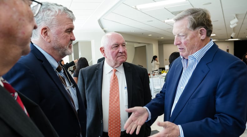 University System of Georgia Chancellor Sonny Perdue, center, is seen during a luncheon following the investiture ceremony for Georgia Gwinnett College President Jann L. Joseph, on April 1, 2022, in Lawrenceville. The college is one of several schools that have asked for more money for construction projects, citing rising costs for materials. (Elijah Nouvelage/Special to the Atlanta Journal-Constitution)