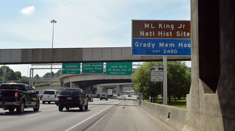 Signs directing motorists to the Carter Center and the MLK Memorial are shown along the downtown connector, Thursday, May 29, 2014. The National Parks Service is negotiating with the Georgia Department of Transportation on altering the placement of signs directing tourists to the King Center. They say the current placement forces tourists to make an abrupt exit from the highway.