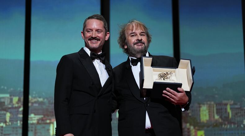 Elijah Wood, from left, and director Peter Jackson, recipient of the honorary Palme d'Or, pose for photographers during the opening ceremony of the 79th international film festival, Cannes, southern France, Tuesday, May 12, 2026. (Photo by Scott A Garfitt/Invision/AP)