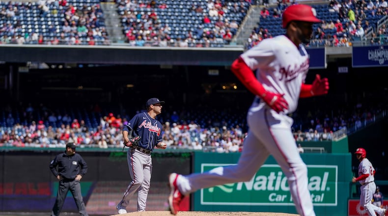 Braves starting pitcher Jared Shuster (left) watches after walking in a run during the first inning of a baseball game against the Washington Nationals at Nationals Park, Sunday, April 2, 2023, in Washington.