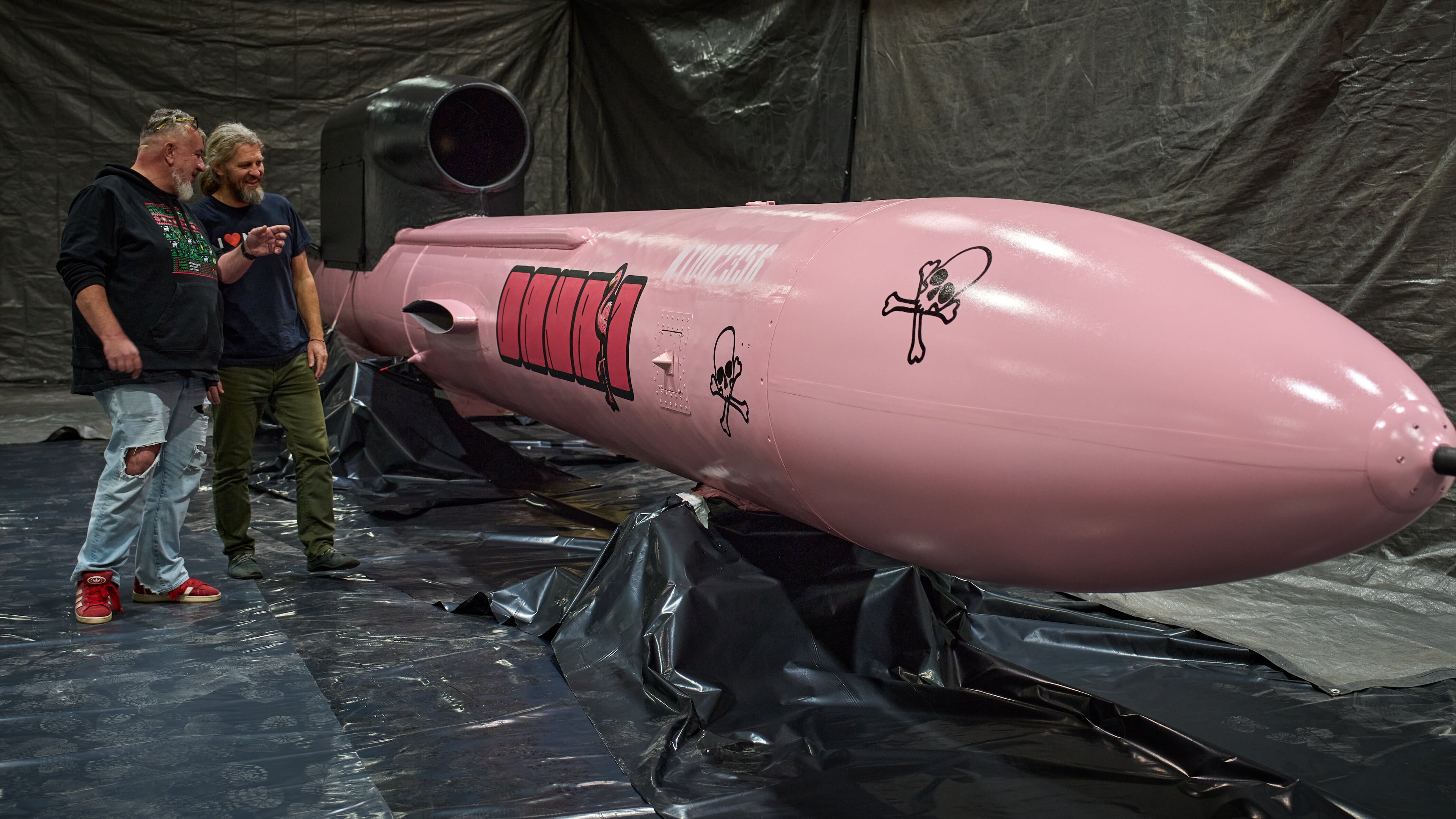 Jan Polak, right, and Martin Ondracek from the Czech organization, Weapons to Ukraine, look at a Flamingo cruise missile which was paid for by their crowdfunding campaign, at the Fire Point factory at an undisclosed location in Ukraine, Sunday, Nov. 16, 2025. (AP Photo/Efrem Lukatsky)