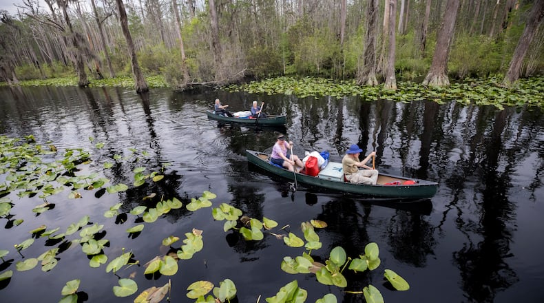 FILE - Visitors return to Stephen C. Foster State Park after an overnight camping trip on the Red Trail in the Okefenokee National Wildlife Refuge in Fargo, Ga., April 6, 2022. (AP Photo/Stephen B. Morton, File)