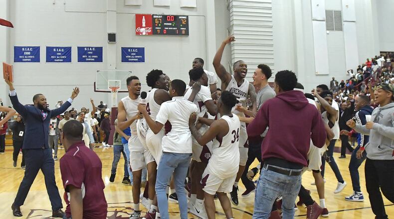 Morehouse players and coaches celebrate their 72-67 victory over Clark Atlanta on Thursday, February 22, 2018. HYOSUB SHIN / HSHIN@AJC.COM