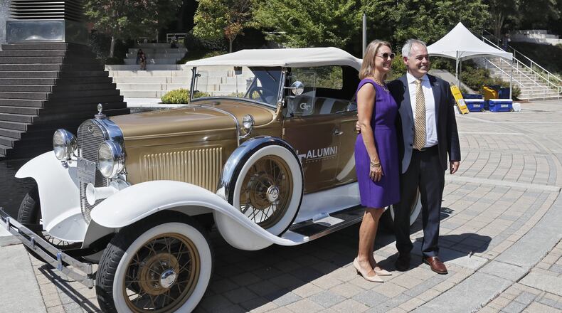 Georgia Tech’s new president, Ángel Cabrera, walked around campus, including this stop at the Ramblin’ Wreck with his wife, Dr. Beth Fraser Cabrera, after he gave his first address since arriving on campus Sept. 1. BOB ANDRES / ROBERT.ANDRES@AJC.COM