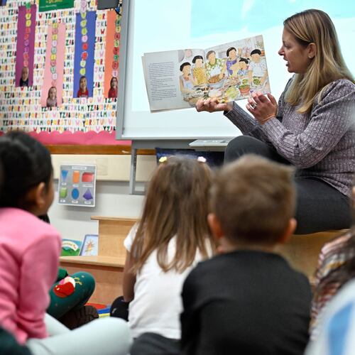 Kindergarten teacher Christin Labriola reads the book "Dumpling Soup" to her class, incorporating Asian American and Pacific Islander subjects in her class at Webster Hill Elementary School in West Hartford, Conn., on Dec. 2, 2025. (AP Photo/Jessica Hill)