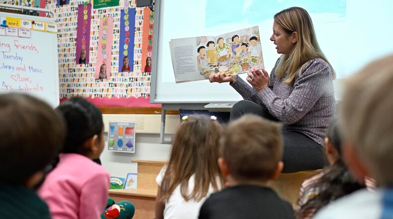 Kindergarten teacher Christin Labriola reads the book "Dumpling Soup" to her class, incorporating Asian American and Pacific Islander subjects in her class at Webster Hill Elementary School in West Hartford, Conn., on Dec. 2, 2025. (AP Photo/Jessica Hill)