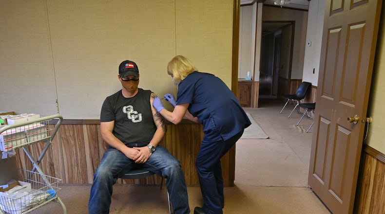 Elbert County High School teacher Kyle Ashworth receives his second dose of the COVID-19 vaccine from Tina Mewborne, LPN, at the Medical Center of Elberton on Wednesday, January 27, 2021. Georgia has not opened COVID-19 vaccination to teachers yet, but a small school district east of Athens still managed to offer shots to any employee who wanted them. Elbert County Superintendent Jon Jarvis told The Atlanta Journal-Constitution that he sees his teachers, bus drivers and other employees as "essential" personnel who should be prioritized for vaccination. (Hyosub Shin / Hyosub.Shin@ajc.com)