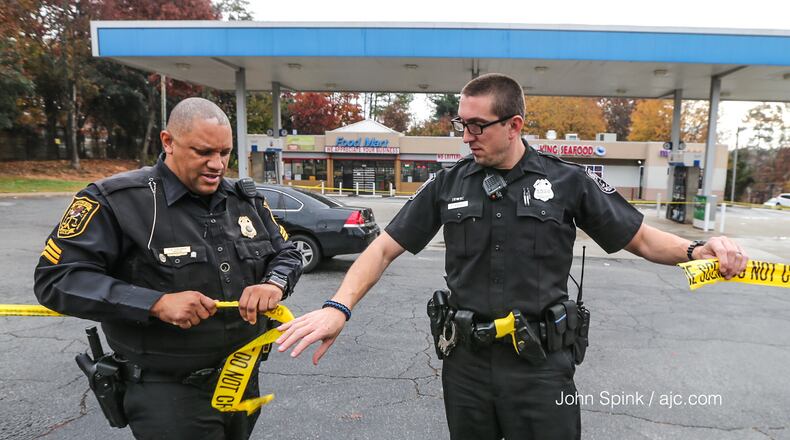 DeKalb County police are investigating a gas station shooting that prompted officials to place Hambrick Elementary School and Stone Mountain High School on lockdown.