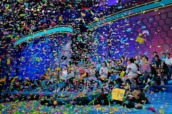 Faizan Zaki, 13, of Dallas, lies on the stage after winning the 2025 Scripps National Spelling Bee Thursday at the Gaylord National Resort & Convention Center in Oxon Hill, Maryland. (Jose Luis Magana/AP)