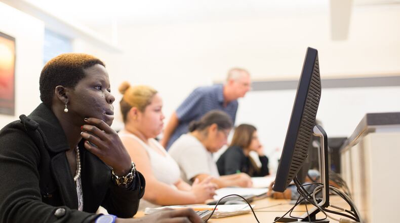 Evelyn Apoko tackles an assignment in a history class at the Austin Community College Eastview campus in 2014 as she worked toward her GED certificate. JULIA ROBINSON / FOR AMERICAN-STATESMAN