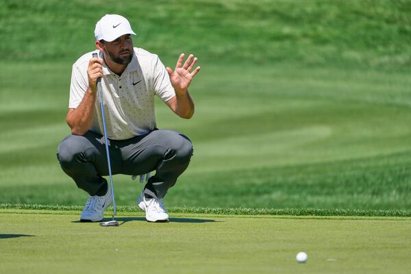 Scottie Scheffler looks over a putt on the fourth hole during the first round of The Players Championship golf tournament Thursday, March 13, 2025, in Ponte Vedra Beach, Fla. (AP Photo/Julia Demaree Nikhinson)