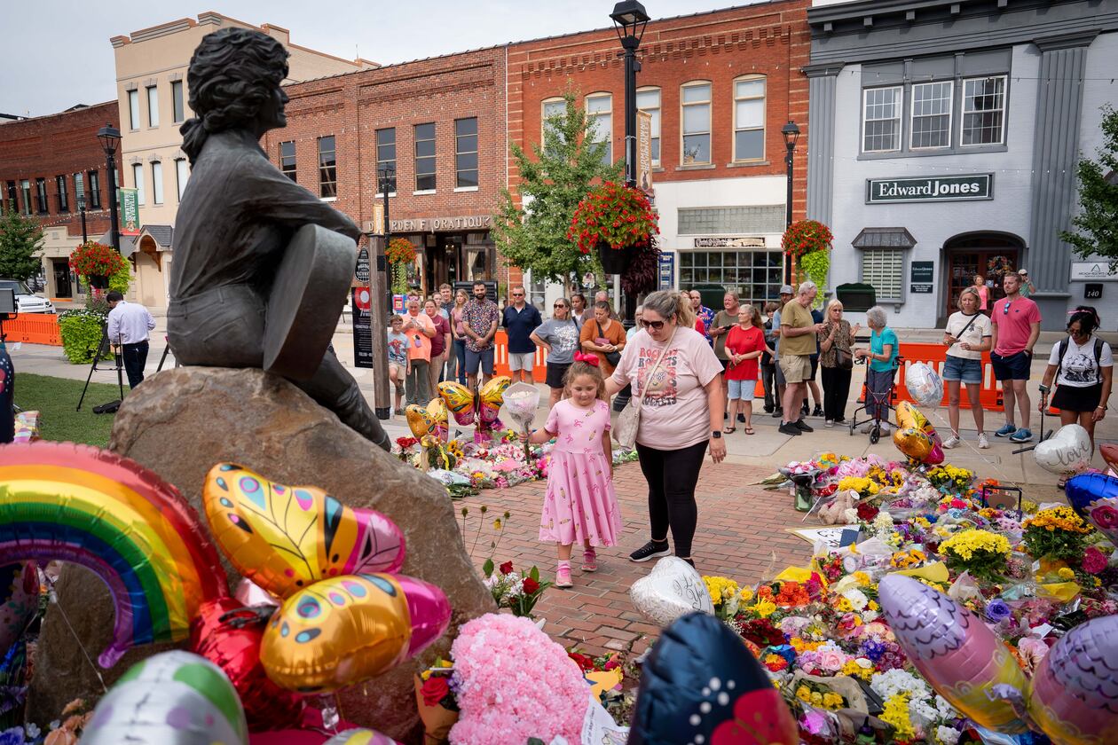 People lay flowers at a memorial honoring the late Dolly Parton in Sevierville, Tenn., on Wednesday, Aug. 26, 2026. (Camden Hall/AP)
