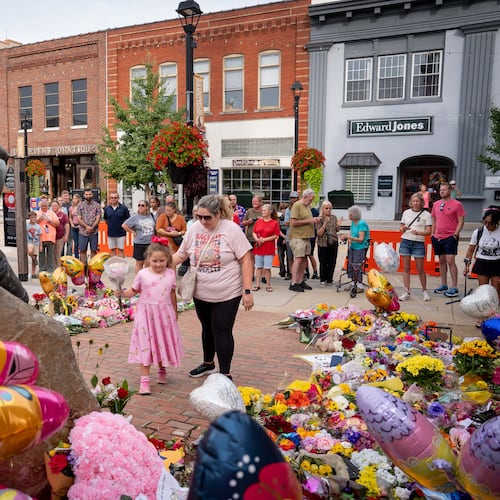 People lay flowers at a memorial honoring the late Dolly Parton in Sevierville, Tenn., on Wednesday, Aug. 26, 2026. (Camden Hall/AP)