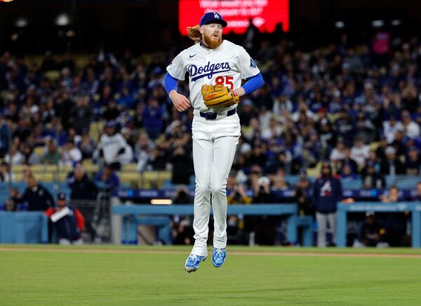 Los Angeles Dodgers' Dustin May jumps in the air after striking out the side against the Atlanta Braves during the first inning of a baseball game Tuesday, April 1, 2025, in Los Angeles. (AP Photo/Kevork Djansezian)