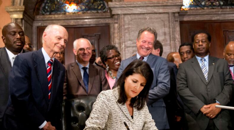 In this July 9, 2015 file photo, South Carolina Gov. Nikki Haley signs a bill to lower the Confederate flag. (AP Photo/John Bazemore, File)