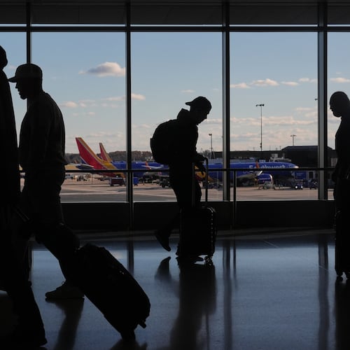 Southwest Airlines planes sit at gates as travelers walk through Baltimore/Washington International Thurgood Marshall Airport in Baltimore, Monday, Nov. 10, 2025. (AP Photo/Stephanie Scarbrough)