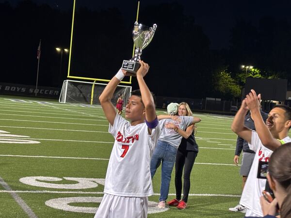 Rigo Torres holds the championship trophy after Dalton defeated Midtown 1-0 for the Class 4A soccer championship, May 15, 2016, at Duluth High School. Torres scored the winning goal and was voted MVP of the game.