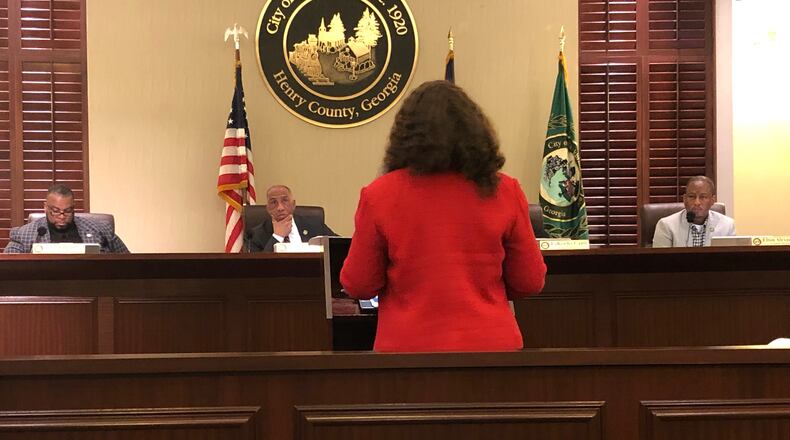 Camilla Moore, Stockbridge Community Development Director, talks to City Councilmembers about establishing impact fees on development. LEON STAFFORD/AJC