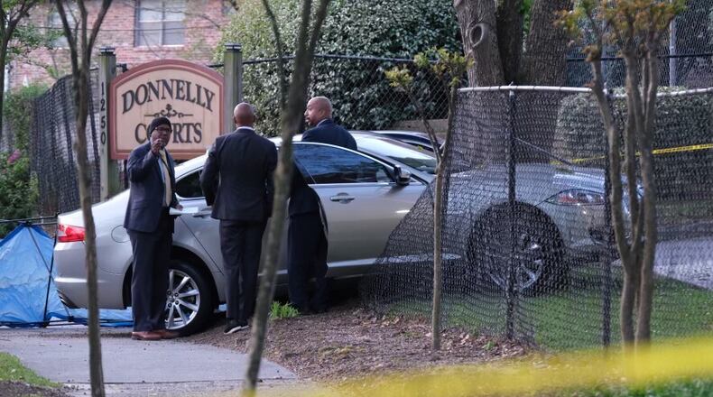 The victim, who appeared to be in his late 30s or early 40s, was found shot and killed inside the sedan after it wrecked into a fence at the Donnelly Courts apartments, according to police.