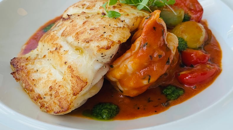 Grilled Branzino fillet with layered potatoes, tomatoes and squash. (Courtesy of Ian Winslade / Tre Vele)