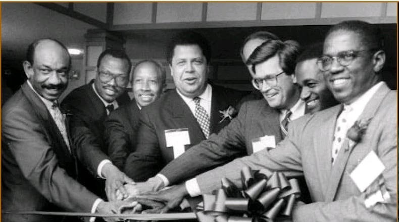 Mayor Maynard Jackson, center, attends a ribbon cutting with Herman Russell, left, Egbert Perry, second from left, and other Atlanta business leaders in approximately 1990. “Maynard created an environment in Atlanta that made it acceptable and even desirable for Black businesses to get opportunities to participate in the economics of the city,” Perry says. (Courtesy of Egbert Perry)