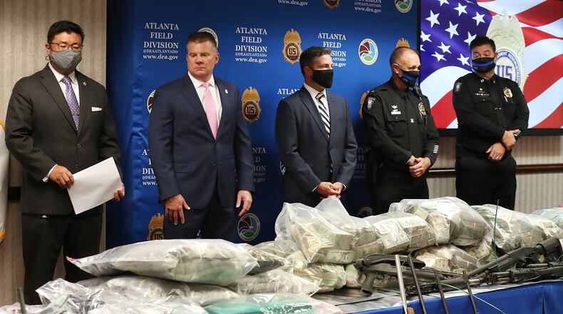 Federal agents displayed seized drugs, cash and firearms during a Wednesday news conference to discuss a massive heroin bust that recently took place in Atlanta.