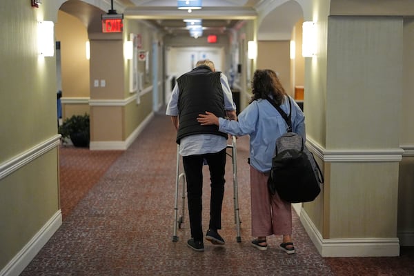 People walk inside the assisted living facility at the Toby and Leon Cooperman Sinai Residences, July 4, 2025, in Boca Raton, Fla. (AP Photo/Rebecca Blackwell)