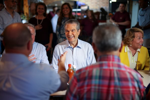Republican nominee for governor Rick Jackson (center) speaks with supporters at a campaign event in Doraville last week. (Jason Getz/AJC)