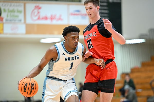 “I want to know how to play off the ball, learn my different reads and see how my defensive game has gotten better,” Cedar Grove’s Manny Green (left), shown driving to the basket under pressure from Gainesville forward Charlie Gersmehl, says. (Daniel Varnado for the AJC)