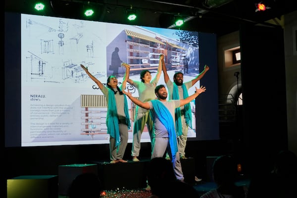 A group of theater artists perform to highlight the benefits of Neralu, an innovative portable heat shelter, at the Sweat and Concrete 2025 event in Bengaluru, India, Thursday, May 29, 2025. (AP Photo/Aijaz Rahi)