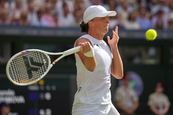 Poland's Iga Swiatek returns to Amanda Anisimova of the U.S. during the women's singles final at the Wimbledon Tennis Championships in London, Saturday, July 12, 2025. (AP Photo/Kin Cheung)
