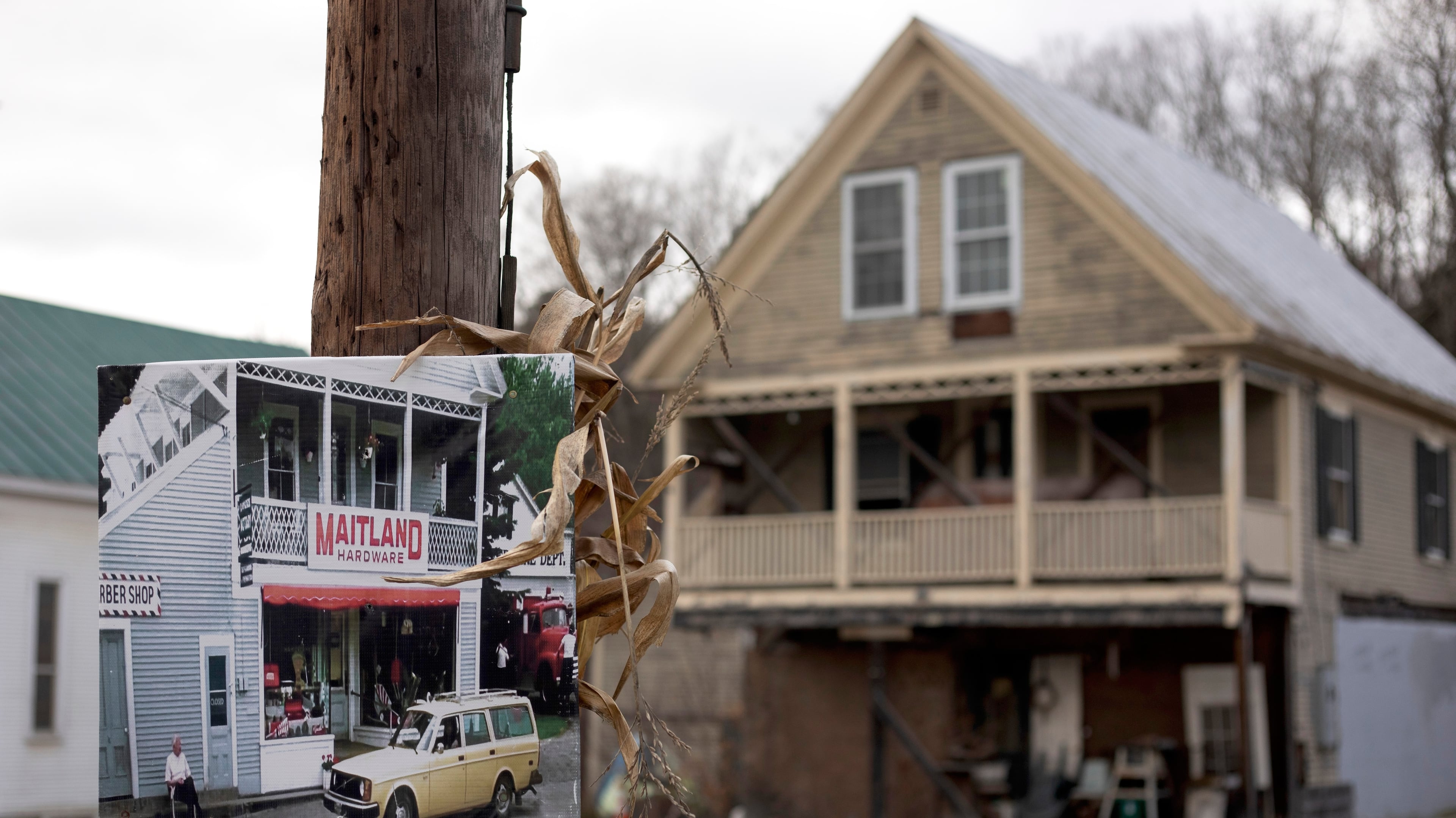 A photo of Maitland Hardware, the fictional hardware store featured in the first "Beetlejuice" film, hangs on a pole in front of the real hardware store used in the filming in East Corinth, Vt., Oct. 28, 2025. (AP Photo/Amanda Swinhart)