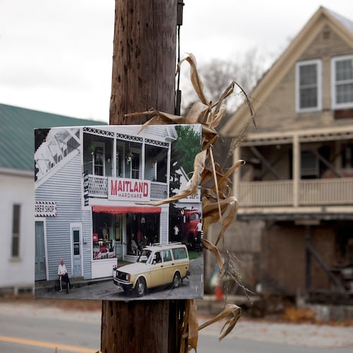 A photo of Maitland Hardware, the fictional hardware store featured in the first "Beetlejuice" film, hangs on a pole in front of the real hardware store used in the filming in East Corinth, Vt., Oct. 28, 2025. (AP Photo/Amanda Swinhart)