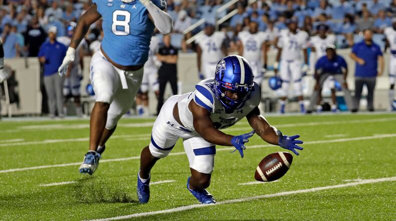 Georgia State running back Marcus Carroll (23) scrambles to recover a fumble ahead of North Carolina defensive lineman Myles Murphy (8) during the first half of an NCAA college football game in Chapel Hill, N.C., Saturday, Sept. 11, 2021. (AP Photo/Chris Seward)