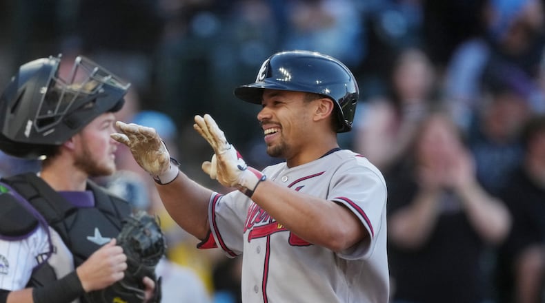 The Braves' Drake Baldwin (right) celebrates as he crosses home plate after hitting a two-run home run in the first inning Saturday, May 2, 2026, in Denver. Baldwin went 3-for-4 with four RBIs, a walk and a run. (David Zalubowski/AP)