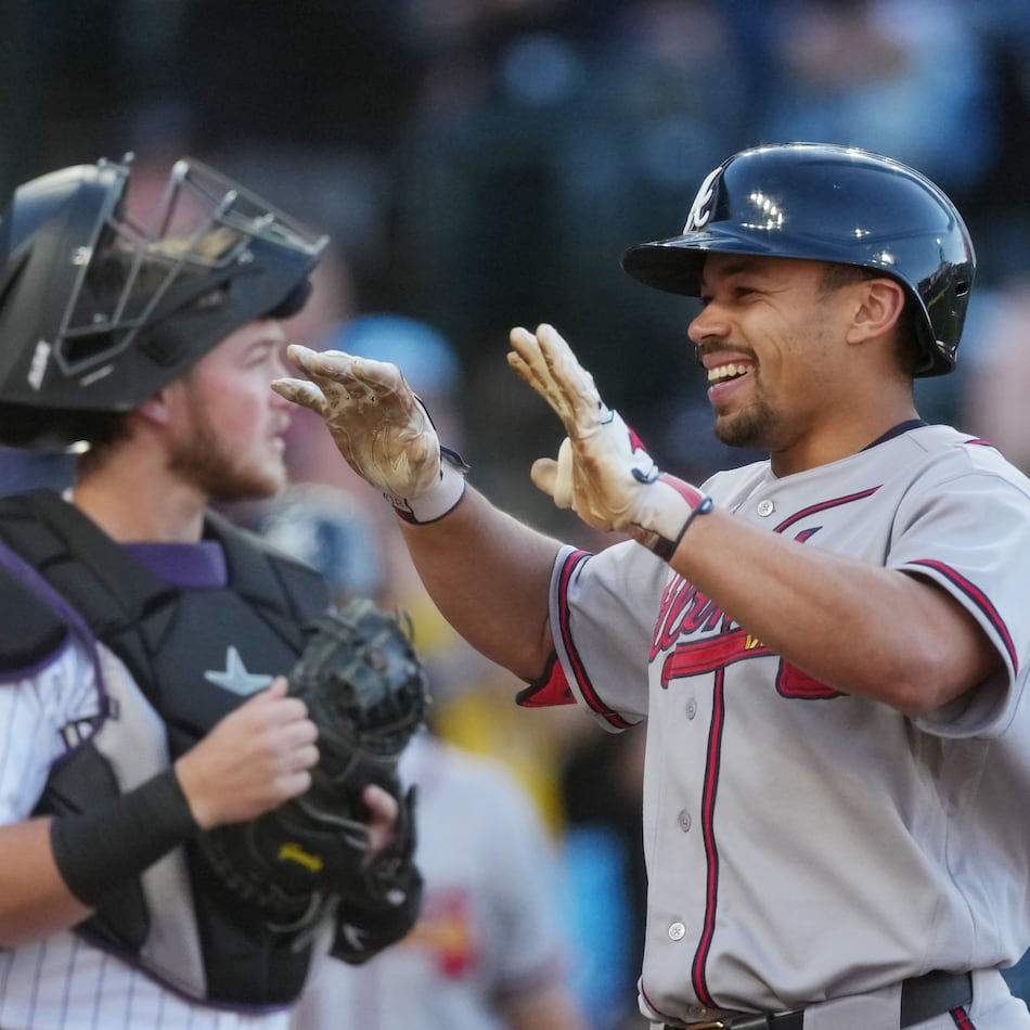 The Braves' Drake Baldwin (right) celebrates as he crosses home plate after hitting a two-run home run in the first inning Saturday, May 2, 2026, in Denver. Baldwin went 3-for-4 with four RBIs, a walk and a run. (David Zalubowski/AP)