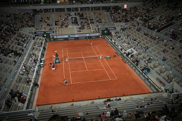 Italy's Jasmine Paolini, bottom, returns the ball to Australia's Ajla Tomljanovic during their second round match of the French Tennis Open, at the Roland-Garros stadium, in Paris, Wednesday, May 28, 2025. (AP Photo/Christophe Ena)