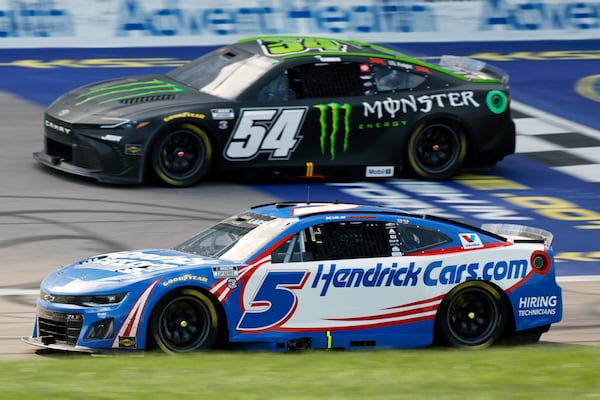 Kyle Larson (5) laps Ty Gibbs (54) during a NASCAR Cup Series auto race at Kansas Speedway in Kansas City, Kan., Sunday, May 11, 2025. (AP Photo/Colin E. Braley)