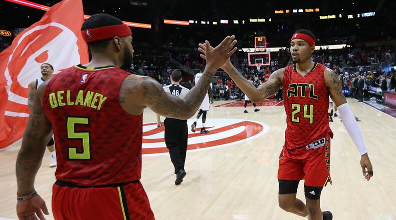 Hawks’ Kent Bazemore (right), who led the team with 24 points, gets five from Malcolm Delaney after beating the Bucks 111-98 in a NBA basketball game on Sunday, Jan. 15, 2017, in Atlanta. Curtis Compton/ccompton@ajc.com