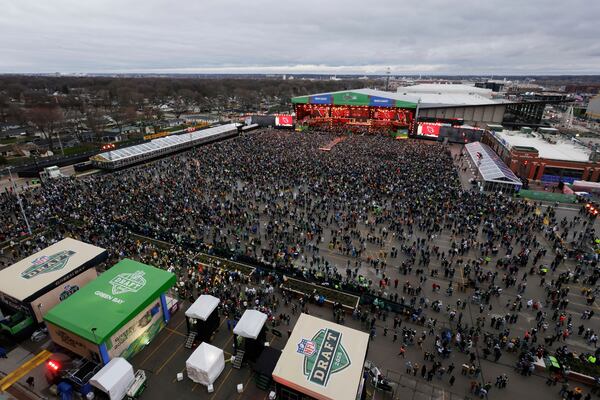 Fans crowd around the draft stage during the second round of the NFL football draft, Friday, April 25, 2025, in Green Bay, Wis. (AP Photo/Matt Ludtke)
