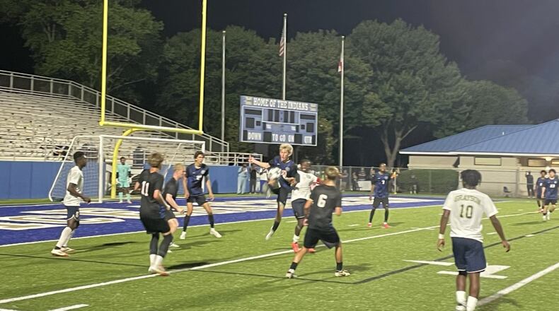 Campbell players (in black) work to clear the ball from their defensive zone in the closing seconds of a 1-0 victory over Grayson in the Class 6A boys soccer championship game at McEachern High School on May 15, 2025.