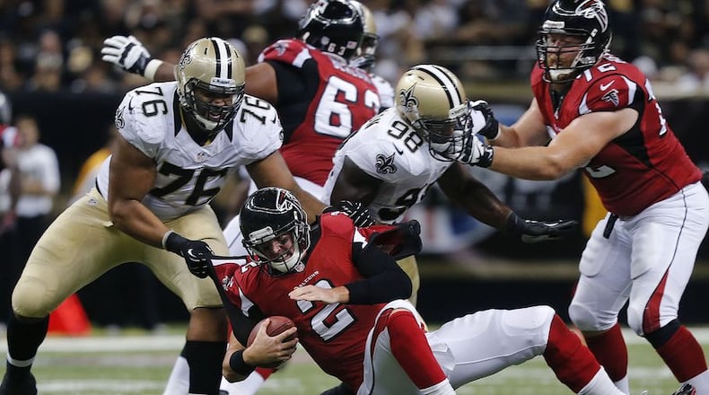 Matt Ryan is sacked by Akiem Hicks, one of three New Orleans sacks in last season's opener at the Superdome. (Bill Haber / Associated Press)