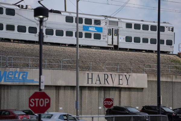 A Metra train leaves the station across from the Pace Harvey Transportation Center, Thursday, May 29, 2025, in Harvey, Ill. (AP Photo/Erin Hooley)