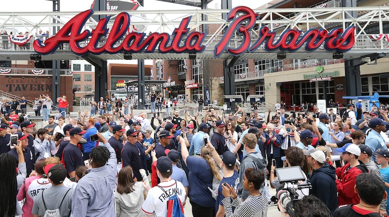 Freddie Freeman (center) and the Braves participate in the 'Brave Walk', a parade by players and coaches down Battery Way and into the Chop House gate prior to Thursday's season opener against the Phillies at SunTrust Park.